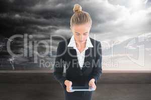 Composite image of businesswoman holding new tablet