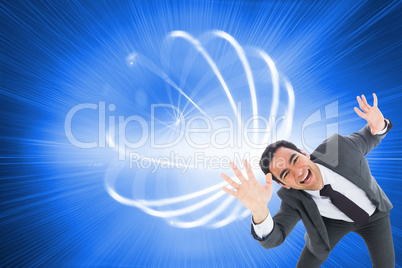 Composite image of excited businessman with arms raised