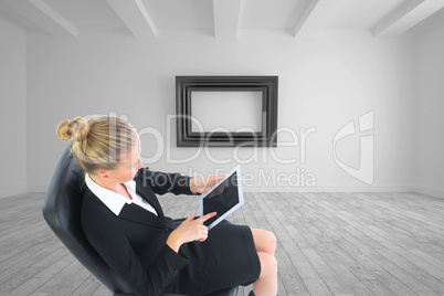 Composite image of businesswoman sitting on swivel chair with ta