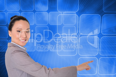 Composite image of smiling asian businesswoman pointing