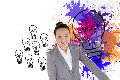 Composite image of smiling asian businesswoman pointing