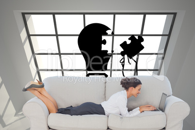 Composite image of business woman lying on couch