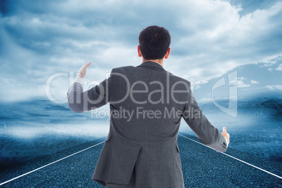 Composite image of businessman catching