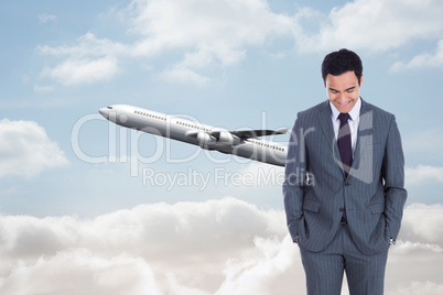 Composite image of smiling businessman standing