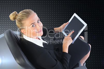 Composite image of businesswoman sitting on swivel chair with ta