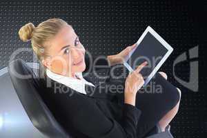 Composite image of businesswoman sitting on swivel chair with ta