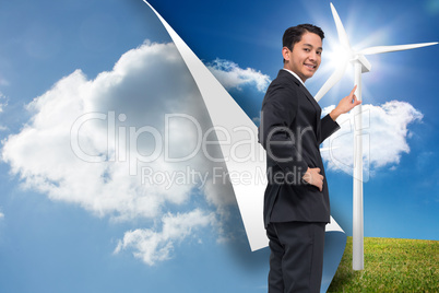 Composite image of smiling asian businessman pointing