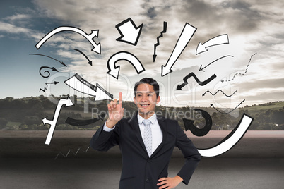 Composite image of smiling asian businessman pointing