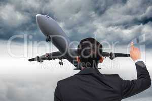 Composite image of asian businessman pointing