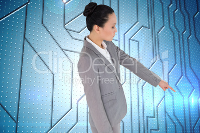 Composite image of unsmiling asian businesswoman pointing