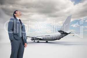 Composite image of smiling businessman standing