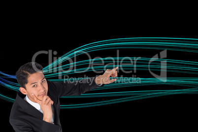 Composite image of thoughtful asian businessman pointing