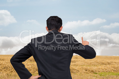 Composite image of asian businessman pointing