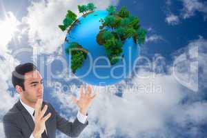 Composite image of unsmiling businessman with arms raised