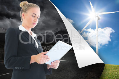 Composite image of businesswoman holding tablet