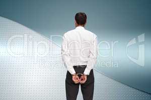 Composite image of rear view of young businessman wearing handcu