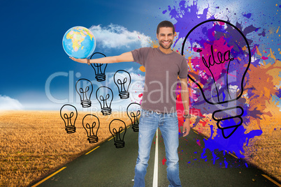 Composite image of handsome man holding out a globe