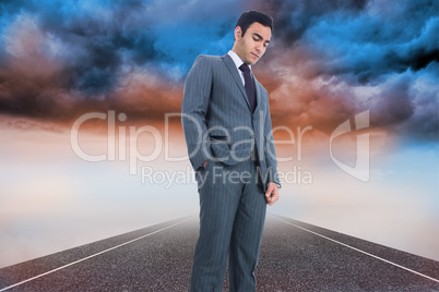 Composite image of unsmiling businessman standing