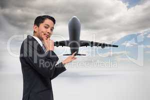 Composite image of thoughtful asian businessman pointing