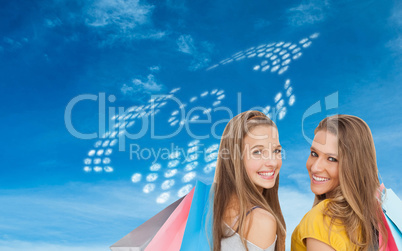 Composite image of two young women with shopping bags