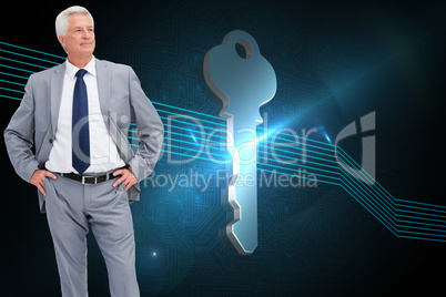 Composite image of man in a suit with his hands on his hips