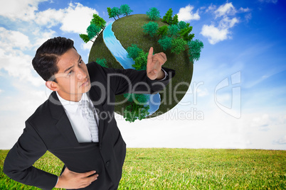 Composite image of unsmiling asian businessman pointing