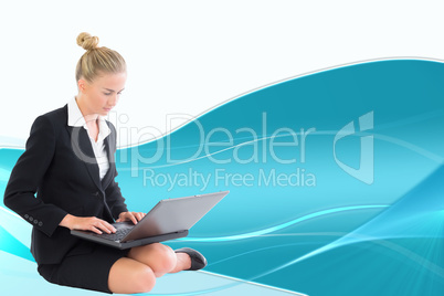 Composite image of businesswoman using laptop