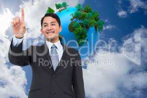 Composite image of smiling asian businessman pointing