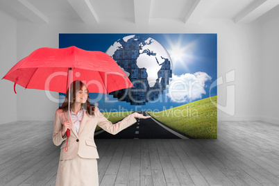 Composite image of attractive businesswoman holding red umbrella