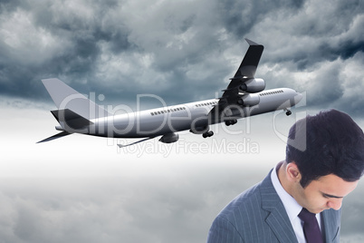 Composite image of unsmiling businessman standing