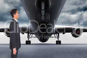 Composite image of smiling businessman looking away