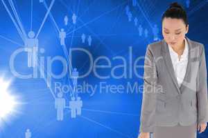 Composite image of unsmiling asian businesswoman pointing