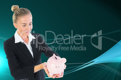 Composite image of businesswoman holding piggy bank