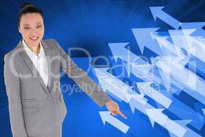 Composite image of smiling asian businesswoman pointing