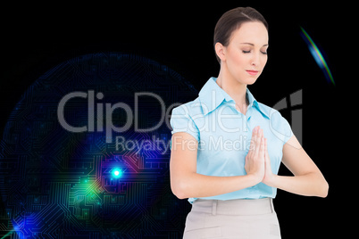 Composite image of peaceful young businesswoman praying