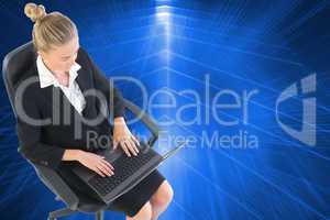 Composite image of businesswoman sitting on swivel chair with la