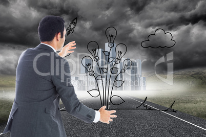 Composite image of businessman catching