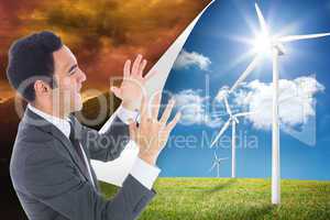 Composite image of excited businessman with arms raised