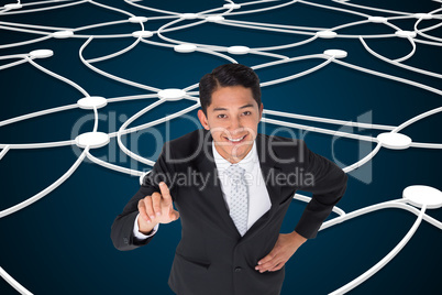 Composite image of smiling asian businessman pointing