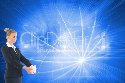 Composite image of businesswoman holding pink piggy bank