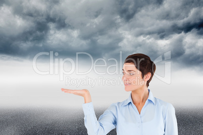 Composite image of businesswoman with an open hand to show a cop