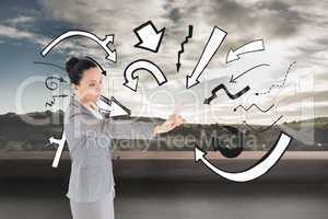 Composite image of unsmiling asian businesswoman pointing