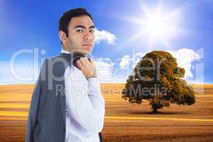 Composite image of unsmiling businessman standing