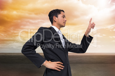 Composite image of unsmiling asian businessman pointing