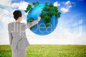 Composite image of asian businesswoman pointing
