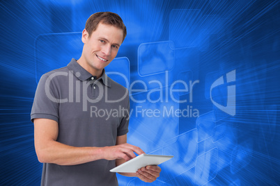 Composite image of smiling young man with tablet computer