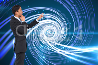 Composite image of thoughtful asian businessman pointing