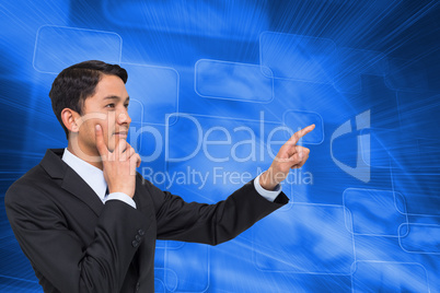 Composite image of thoughtful asian businessman pointing