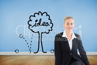 Composite image of young businesswoman sitting on ground