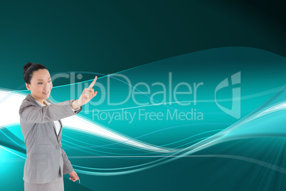 Composite image of smiling asian businesswoman pointing